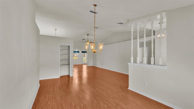 interior space featuring a chandelier, hardwood / wood-style flooring, and vaulted ceiling