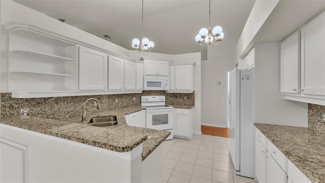 kitchen with white cabinets, white appliances, sink, and an inviting chandelier