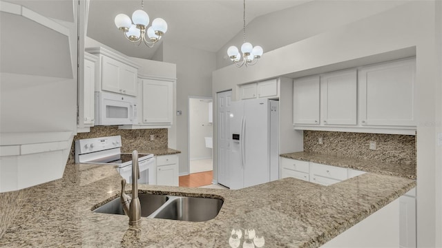 kitchen featuring tasteful backsplash, white appliances, decorative light fixtures, a chandelier, and white cabinetry