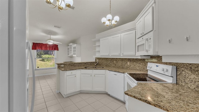 kitchen featuring pendant lighting, ceiling fan with notable chandelier, white appliances, and white cabinetry