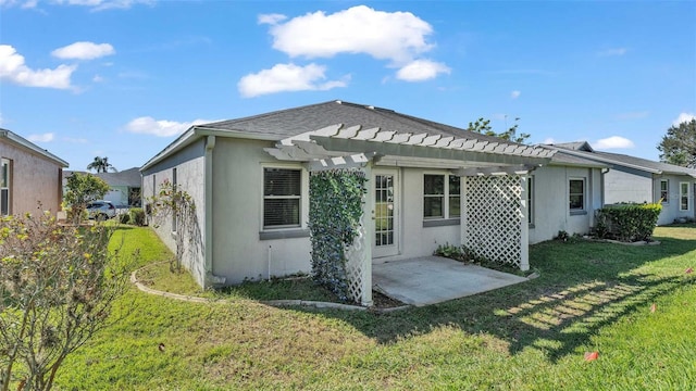 back of house featuring a lawn, a pergola, and a patio area