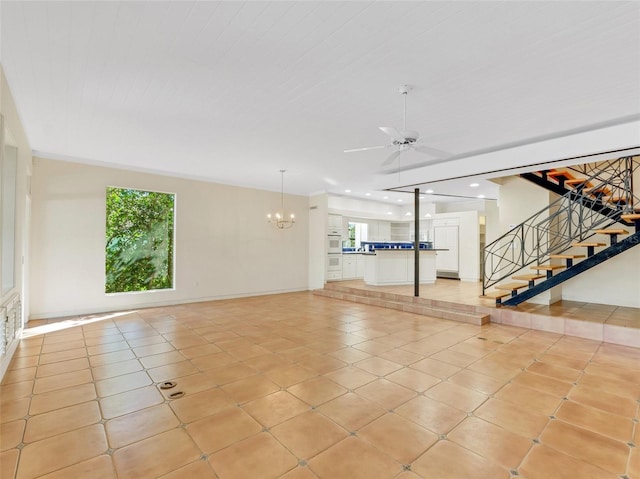 interior space featuring ceiling fan with notable chandelier