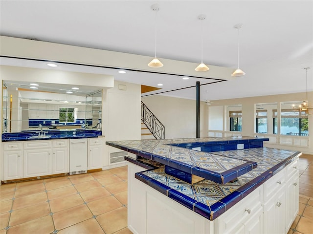 kitchen with a kitchen island, white cabinetry, hanging light fixtures, and tasteful backsplash