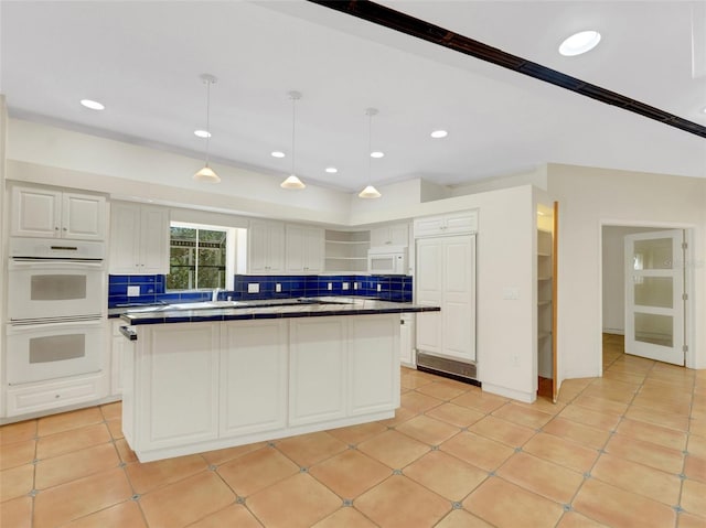 kitchen with pendant lighting, white appliances, white cabinets, decorative backsplash, and light tile patterned floors