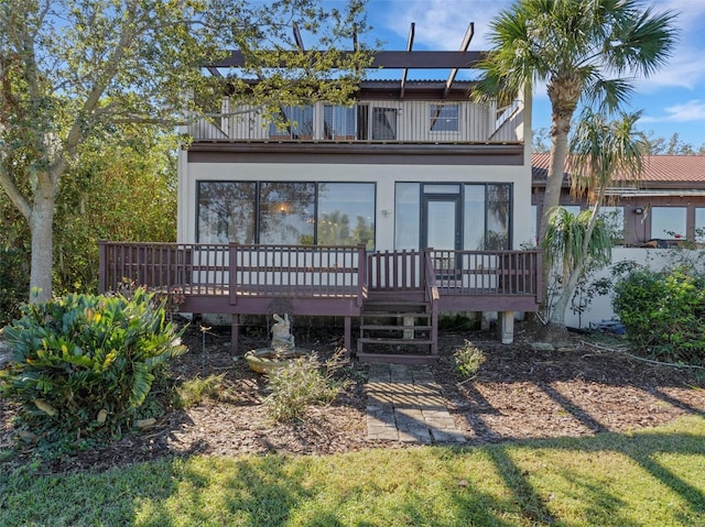 back of property with a wooden deck