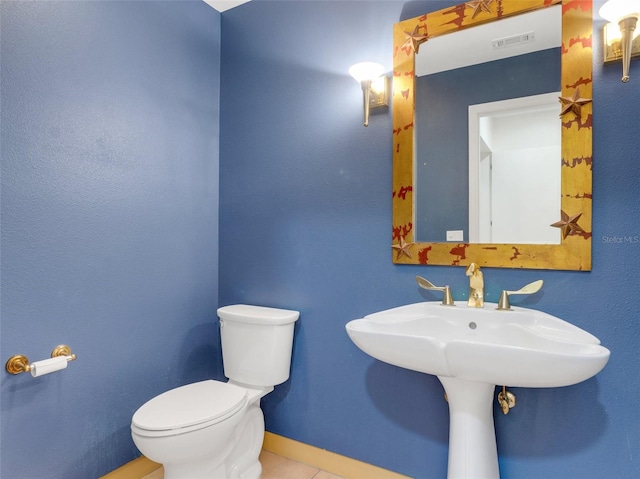 bathroom with tile patterned floors and toilet