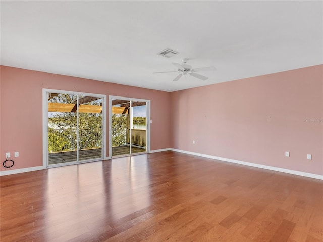 spare room with light hardwood / wood-style flooring and ceiling fan