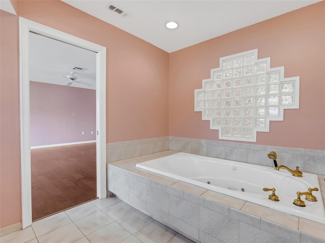 bathroom with tile patterned floors and tiled tub