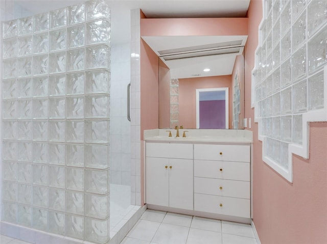 bathroom with tile patterned floors, vanity, and tiled shower