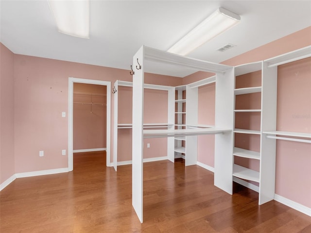 spacious closet with hardwood / wood-style floors