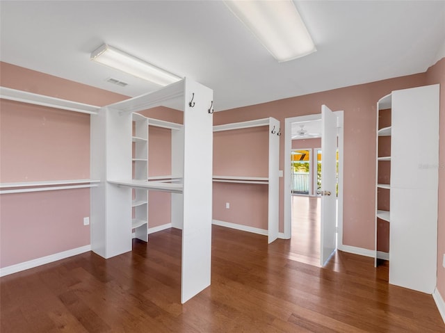 spacious closet with dark wood-type flooring