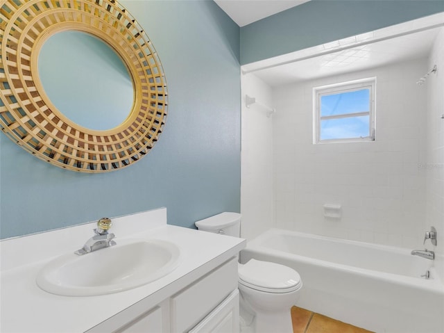 full bathroom featuring tile patterned floors, vanity, tiled shower / bath combo, and toilet