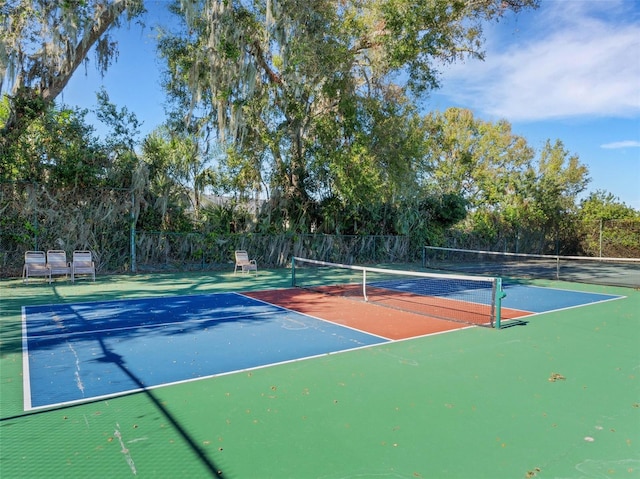 view of tennis court with basketball hoop