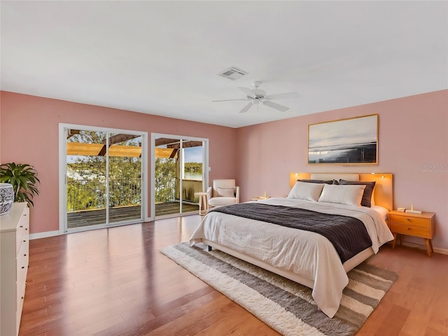 bedroom with ceiling fan, access to exterior, and light hardwood / wood-style flooring