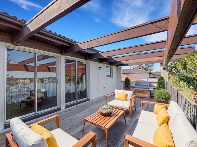 deck with an outdoor hangout area and area for grilling