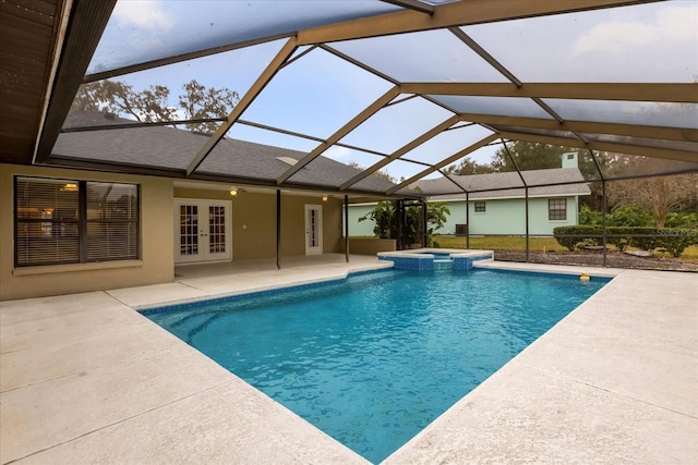 view of pool with french doors, glass enclosure, and a patio area