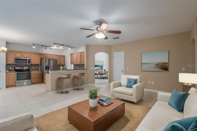 living room featuring light tile patterned floors and ceiling fan