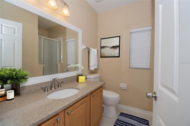 bathroom with tile patterned flooring, vanity, a shower with shower door, and toilet