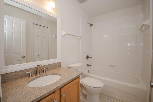 full bathroom with tile patterned floors, tiled shower / bath, vanity, and toilet