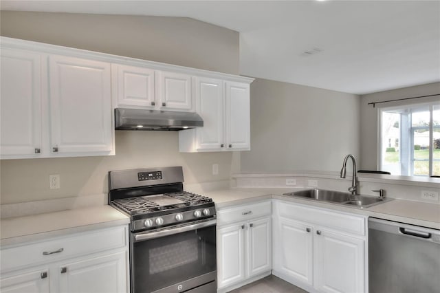 kitchen featuring white cabinetry, sink, stainless steel appliances, and vaulted ceiling