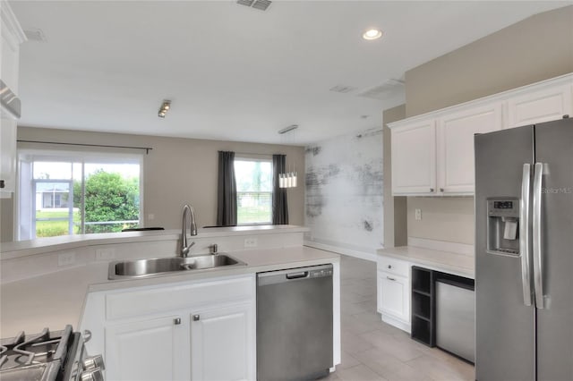 kitchen featuring sink, white cabinetry, and stainless steel appliances