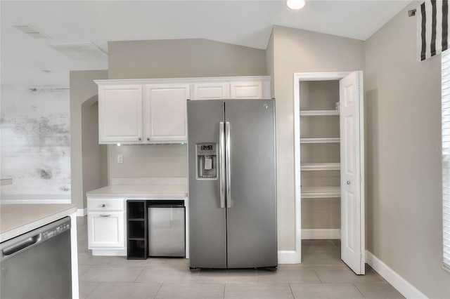 kitchen with white cabinets, lofted ceiling, and stainless steel appliances