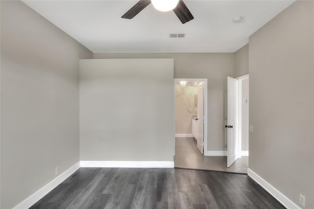 spare room featuring dark hardwood / wood-style flooring and ceiling fan