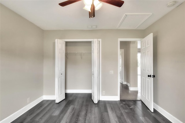 unfurnished bedroom with ceiling fan, dark wood-type flooring, and a closet