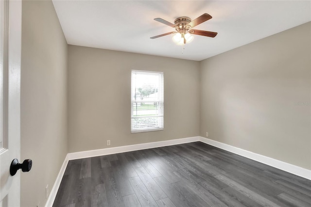 empty room with ceiling fan and dark hardwood / wood-style flooring