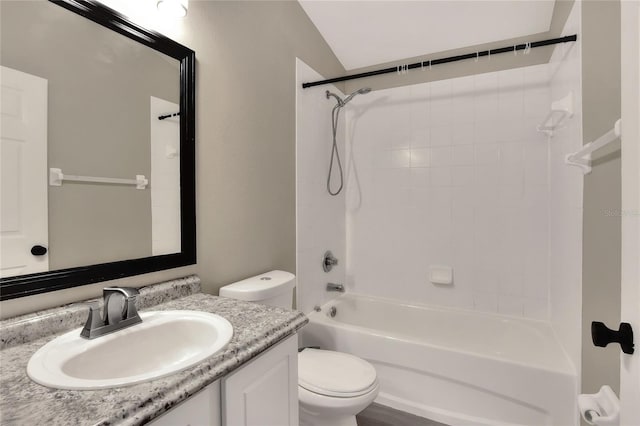 full bathroom featuring tiled shower / bath combo, toilet, vanity, and vaulted ceiling