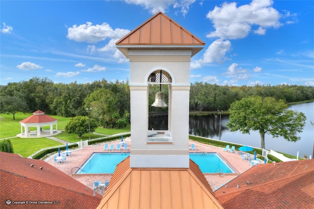 view of pool with a gazebo and a water view