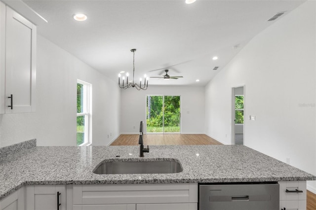 kitchen featuring ceiling fan with notable chandelier, white cabinetry, and sink