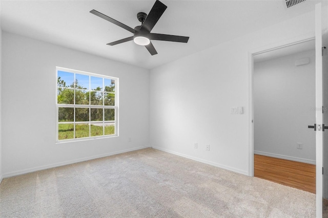 carpeted empty room featuring ceiling fan