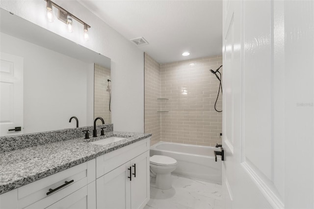 full bathroom with vanity, toilet, and tiled shower / bath combo