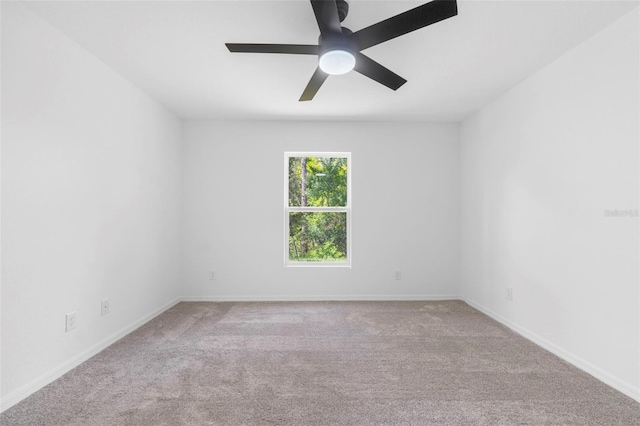 spare room with ceiling fan and light colored carpet