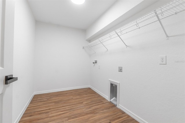 washroom with hookup for an electric dryer, hardwood / wood-style floors, and washer hookup