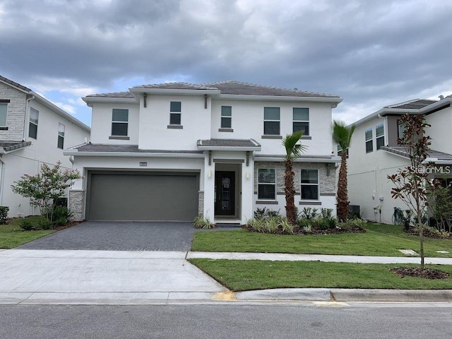 view of front of house featuring a front yard and a garage