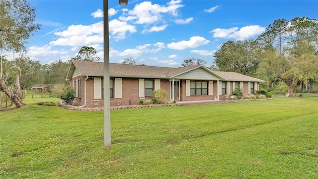 ranch-style home featuring a front yard