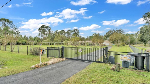 view of gate with a yard