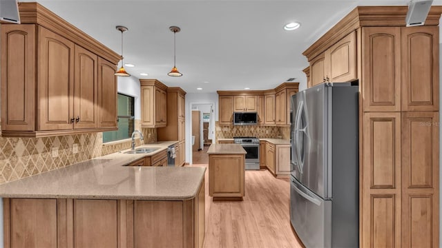 kitchen featuring decorative backsplash, light wood-type flooring, stainless steel appliances, sink, and hanging light fixtures