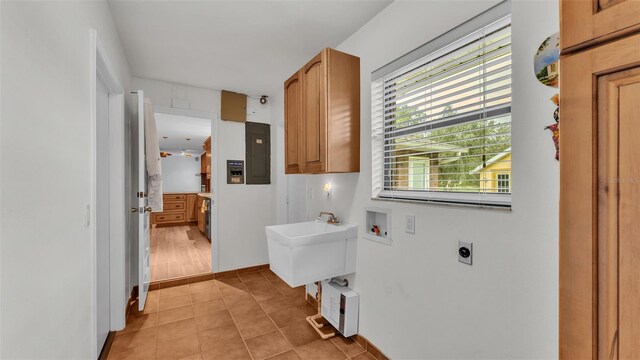 laundry room featuring cabinets, washer hookup, electric dryer hookup, electric panel, and light tile patterned floors