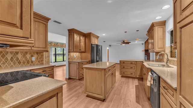 kitchen with a center island, stainless steel appliances, light hardwood / wood-style floors, and sink