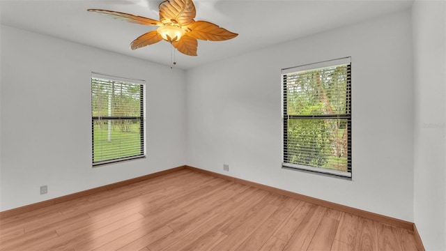 unfurnished room with ceiling fan and light wood-type flooring