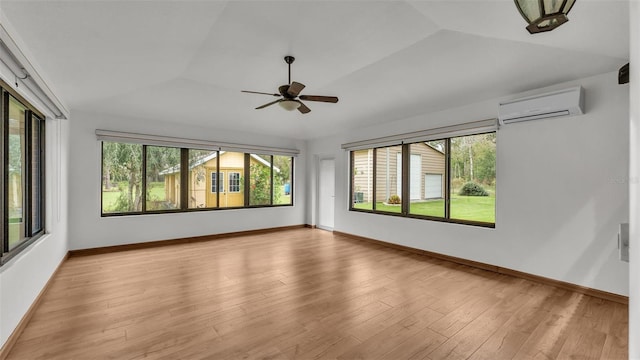 9240 Moore Rd, Lakeland, FL 33809 - empty room with a wall mounted AC, plenty of natural light, light wood-type flooring, ceiling fan, and vaulted ceiling