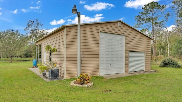 view of outdoor structure with a lawn and a garage