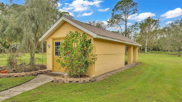 view of outbuilding featuring a yard