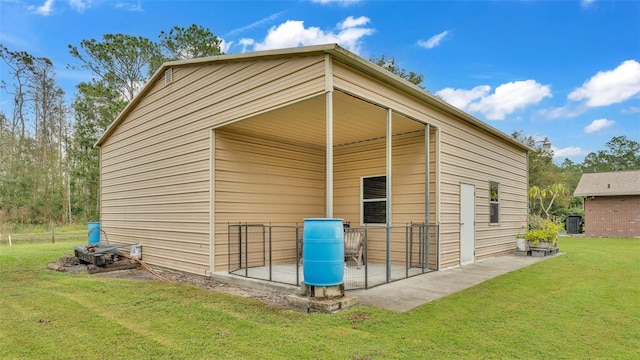 view of outbuilding with a lawn