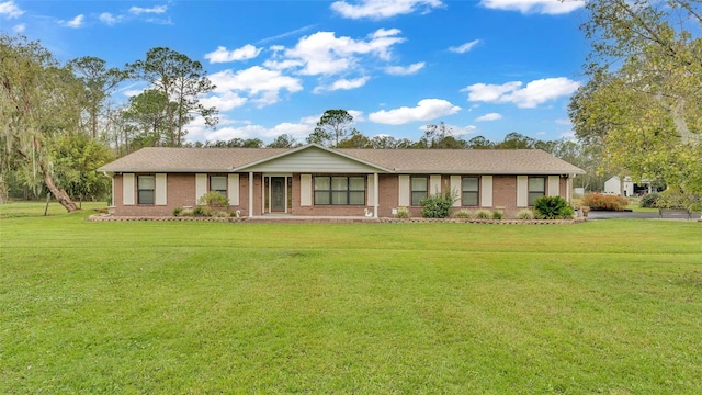 9240 Moore Rd, Lakeland, FL 33809 - ranch-style house with brick siding and a front yard