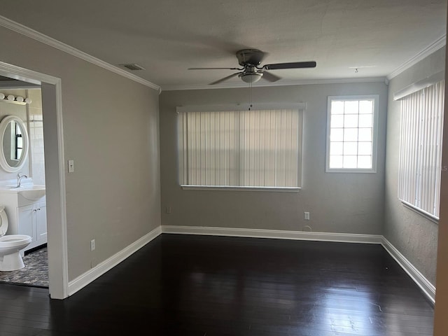 unfurnished room featuring ceiling fan, sink, dark wood-type flooring, and ornamental molding