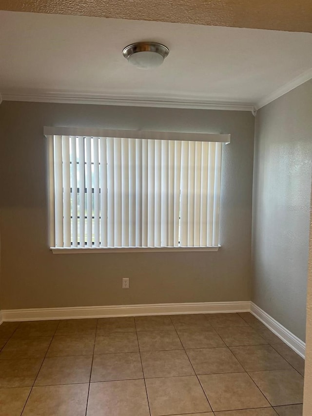 tiled empty room with crown molding